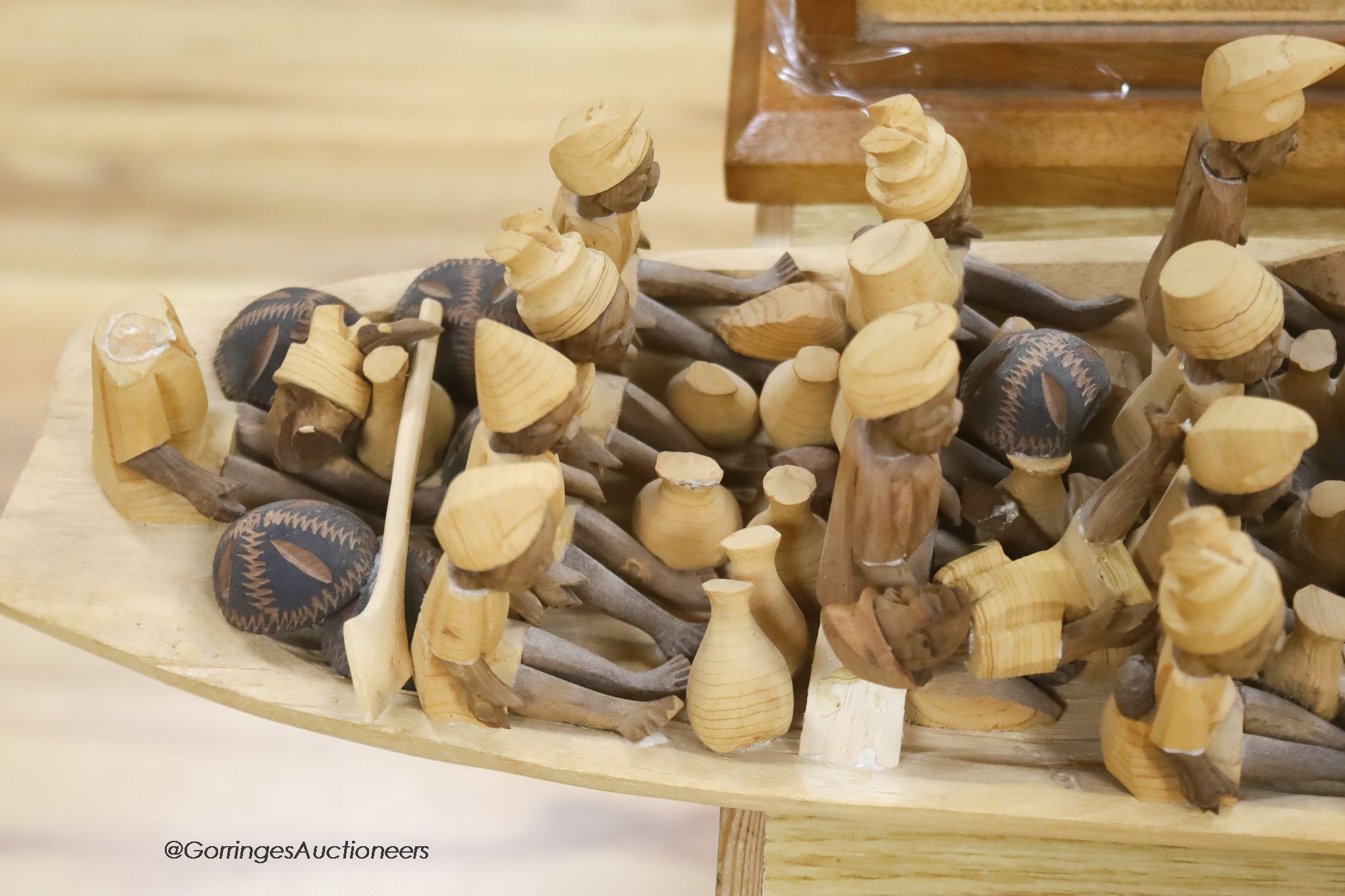 An African wood model of figures in a boat, length 155cm